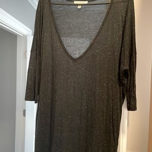 Low V-neck t-shirt. You will need a cami underneath. Fits loosely. Never worn!